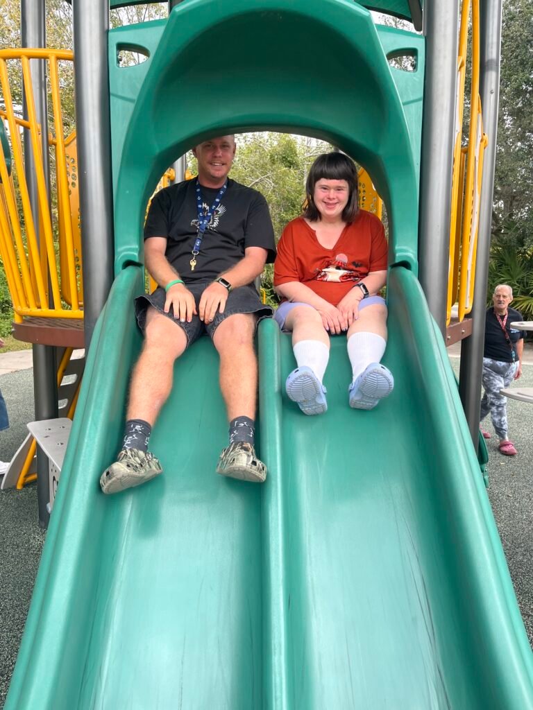 Participants enjoying a slide together on a community outing