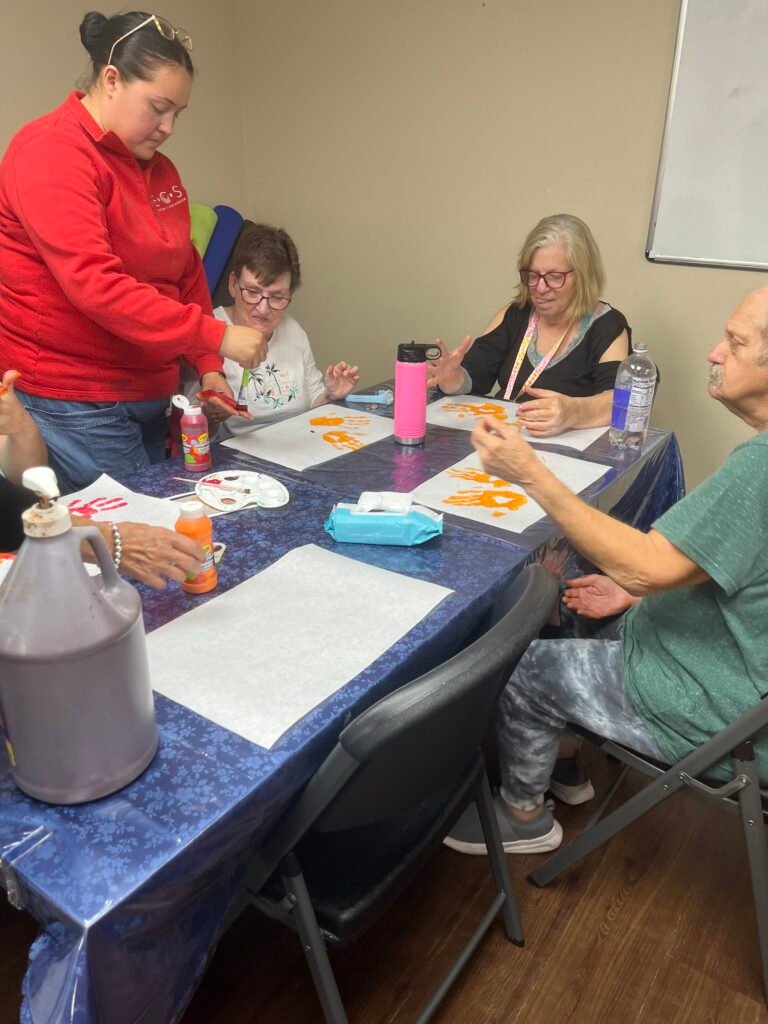 Participants and staff sharing time together around a table