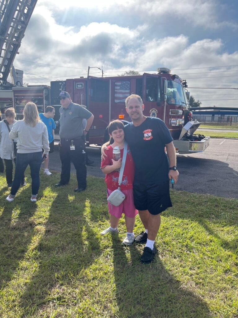 Participants and staff visiting a fire truck on a community outing
